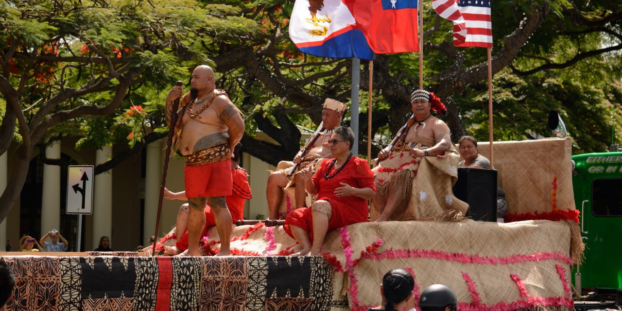 Samoans with the flag of the US, Samoa and American Samoa. Photo credit: Daniel Ramirez