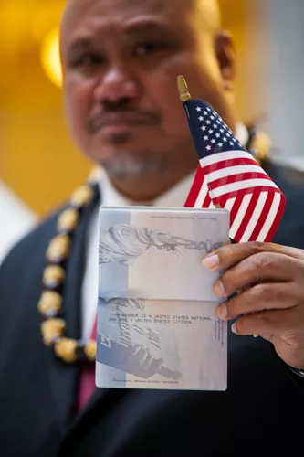 John Fitisemanu holding his American national passport that states: "THE BEARER IS A UNITED STATES NATIONAL AND NOT A UNITED STATES CITIZEN." Photo credit: Equally American