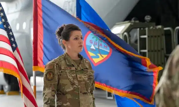 Tech. Sgt. Joanne Griffin, Pacific Air Forces Regional Band vocalist, stands at attention during the posting of the colors at the Operation Christmas Drop 2023 (OCD 23) Push Ceremony, December 4, 2023, at Andersen Air Force Base, Guam. Photo credit: Taylor Altier, US Air Force