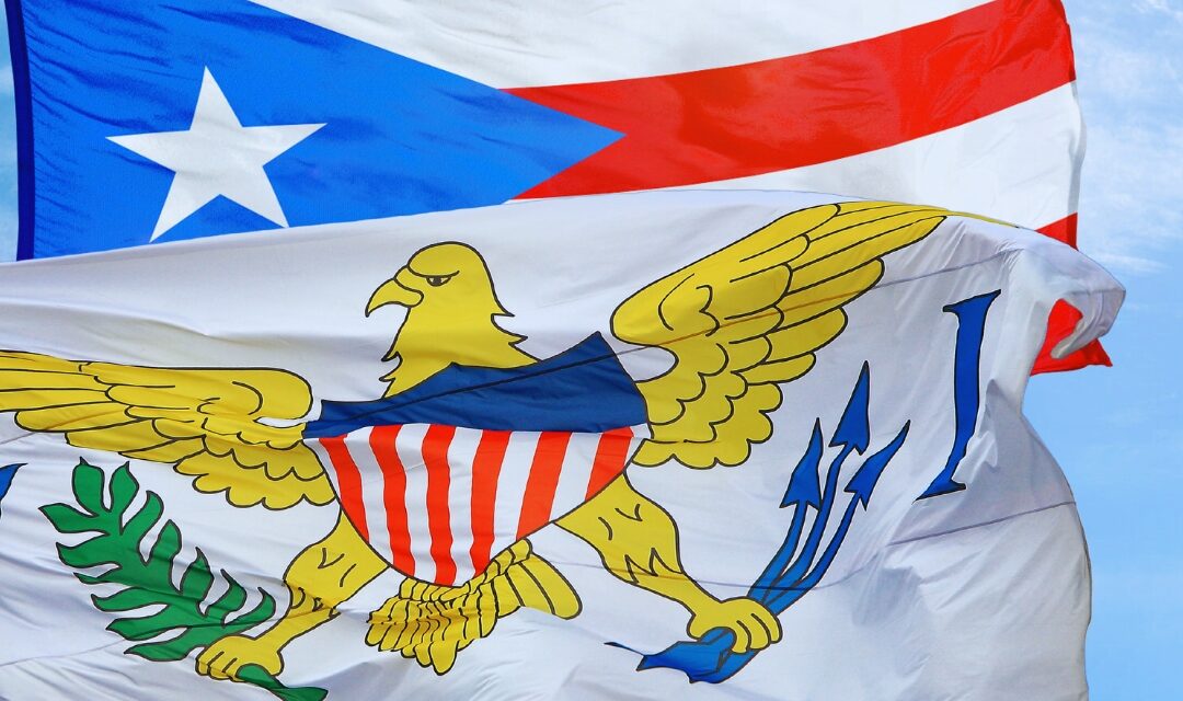 Puerto Rico and United States Virgin Islands flags waving in the wind.